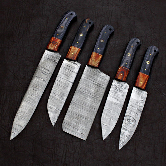 Macro view of a Damascus steel kitchen knife blade showing detailed hand ground edges and high quality steel finish.