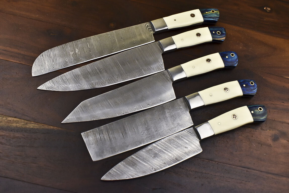 Complete 5 pieces Damascus steel chef knife set arranged with their hand tooled leather sheaths.