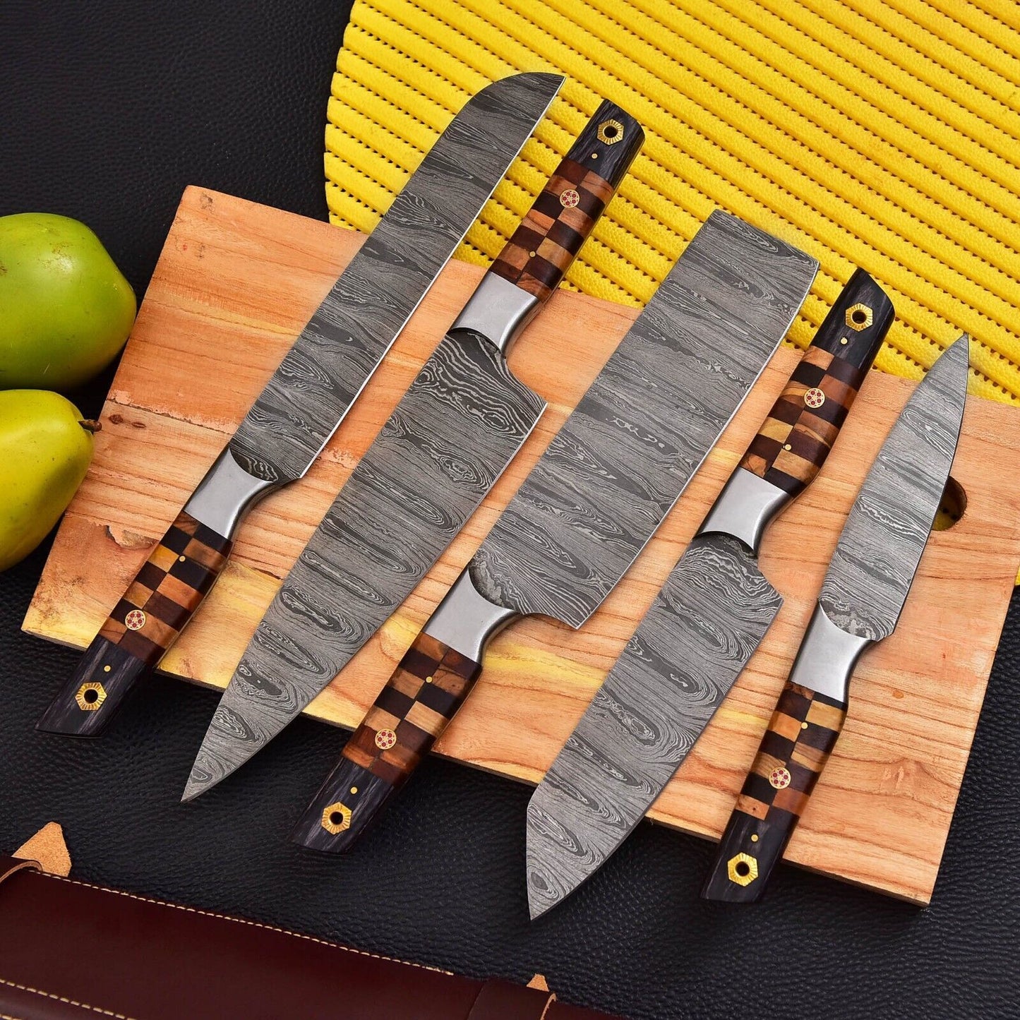 Detail view of a premium wood handle on a custom hand forged Damascus steel kitchen knife, highlighting grip and artisanal craftsmanship.