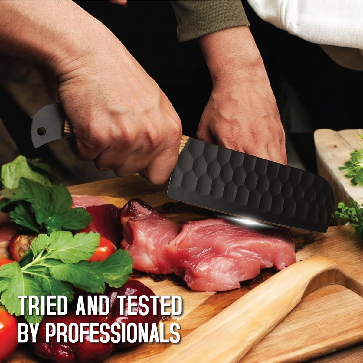 Two hands using a black cleaver to cut meat on a wooden chopping board