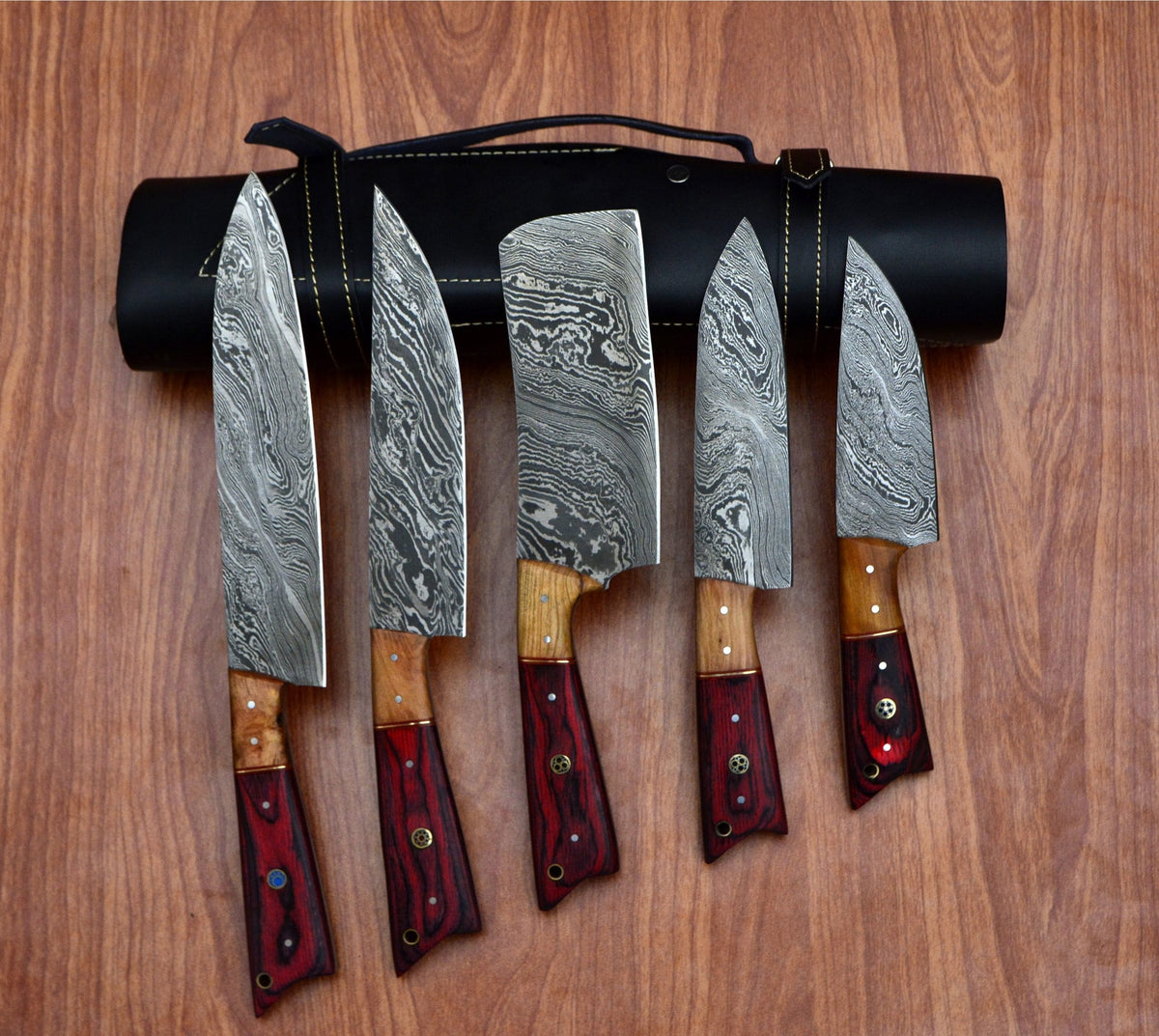 5 piece Damascus steel chef knife set in a row with black leather roll case