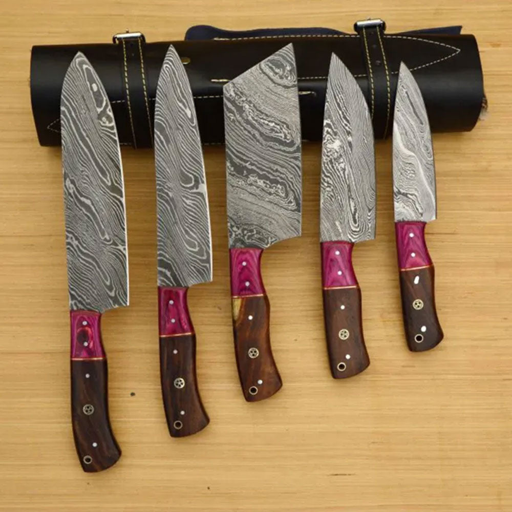 Damascus knife set before a rolled leather bag.