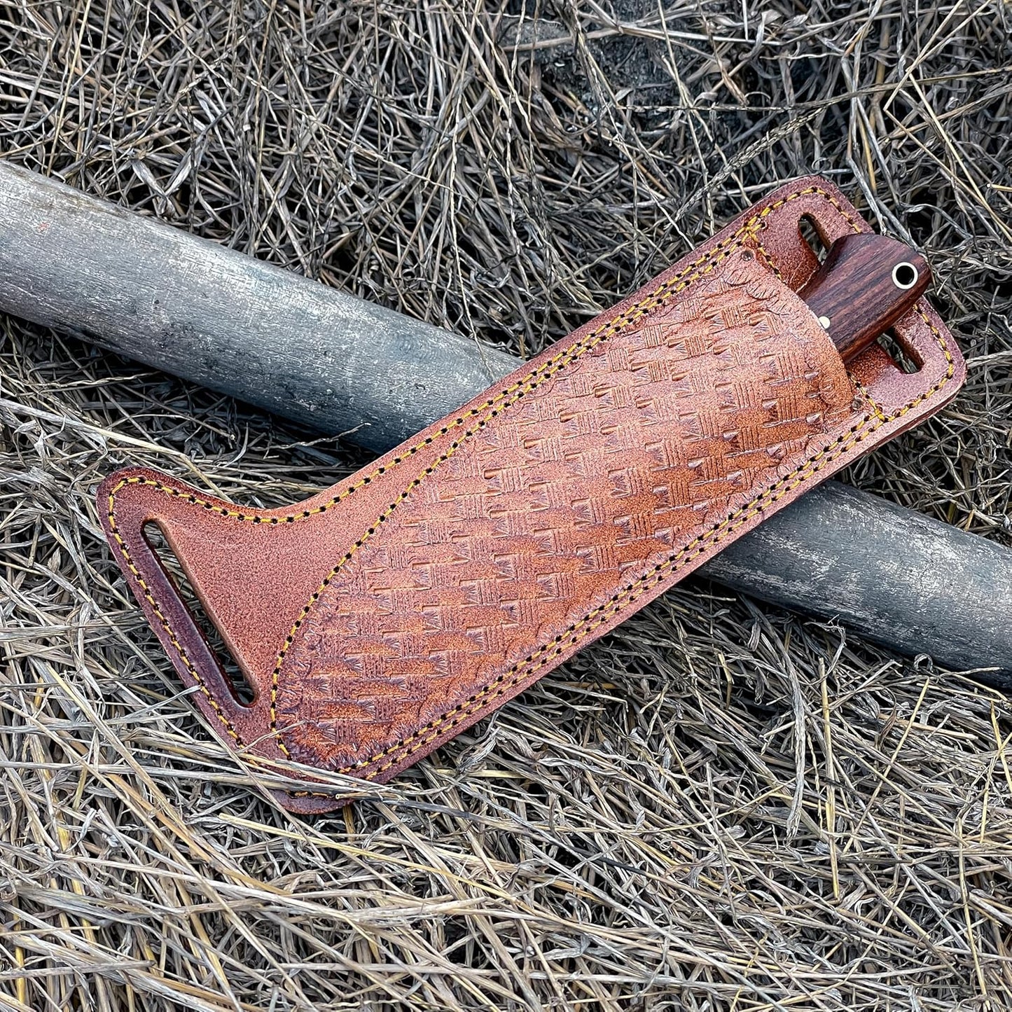 Best Fixed Blade Knife handle visible in basket-weave leather sheath outdoors