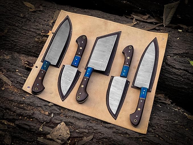 Damascus knives with blue resin and wood handles laid across an open knife roll
