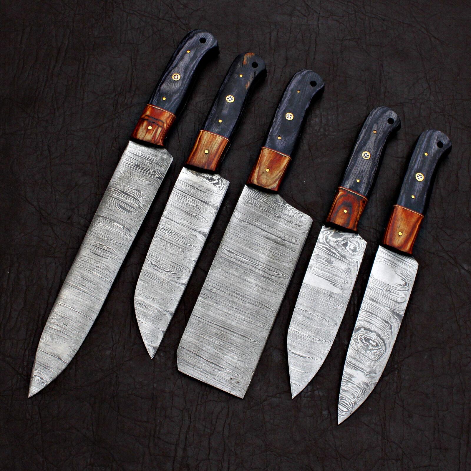 Macro view of a Damascus steel kitchen knife blade showing detailed hand ground edges and high quality steel finish.