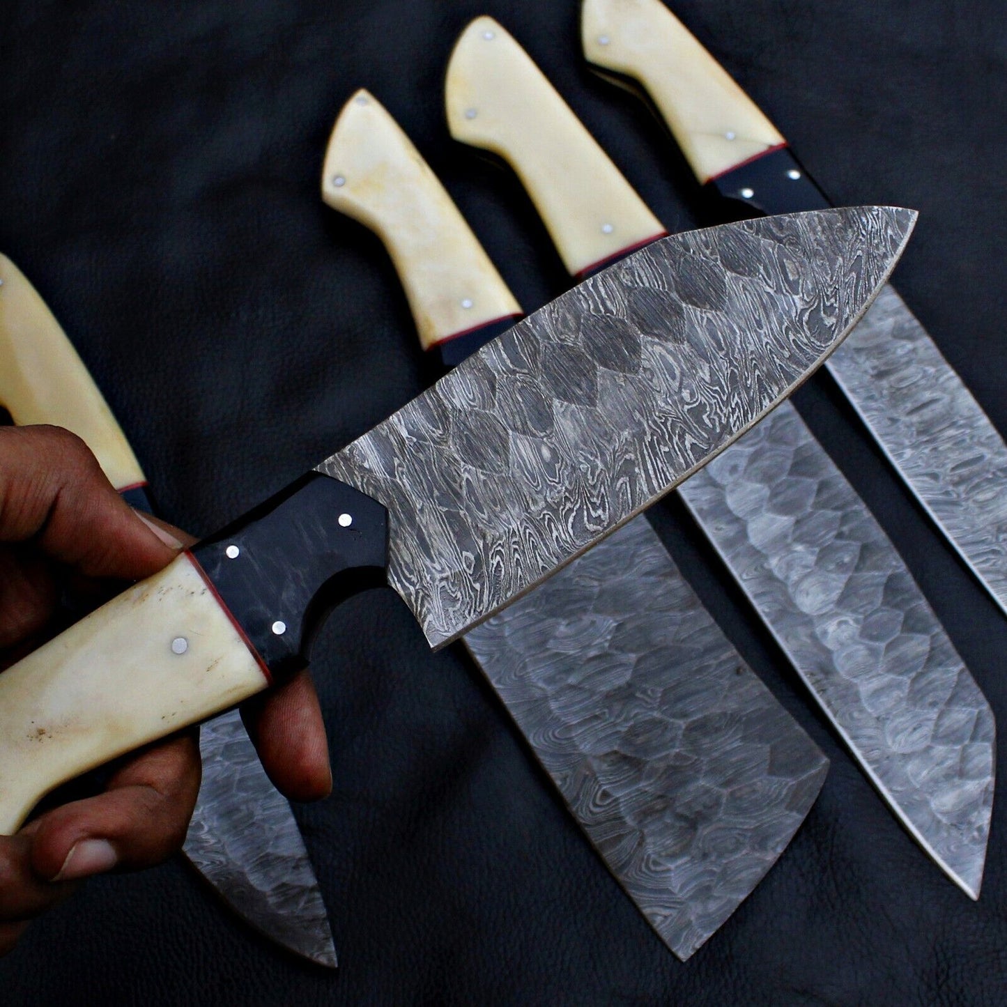 Close up of unique, hand forged Damascus steel pattern on a professional kitchen chef knife.
