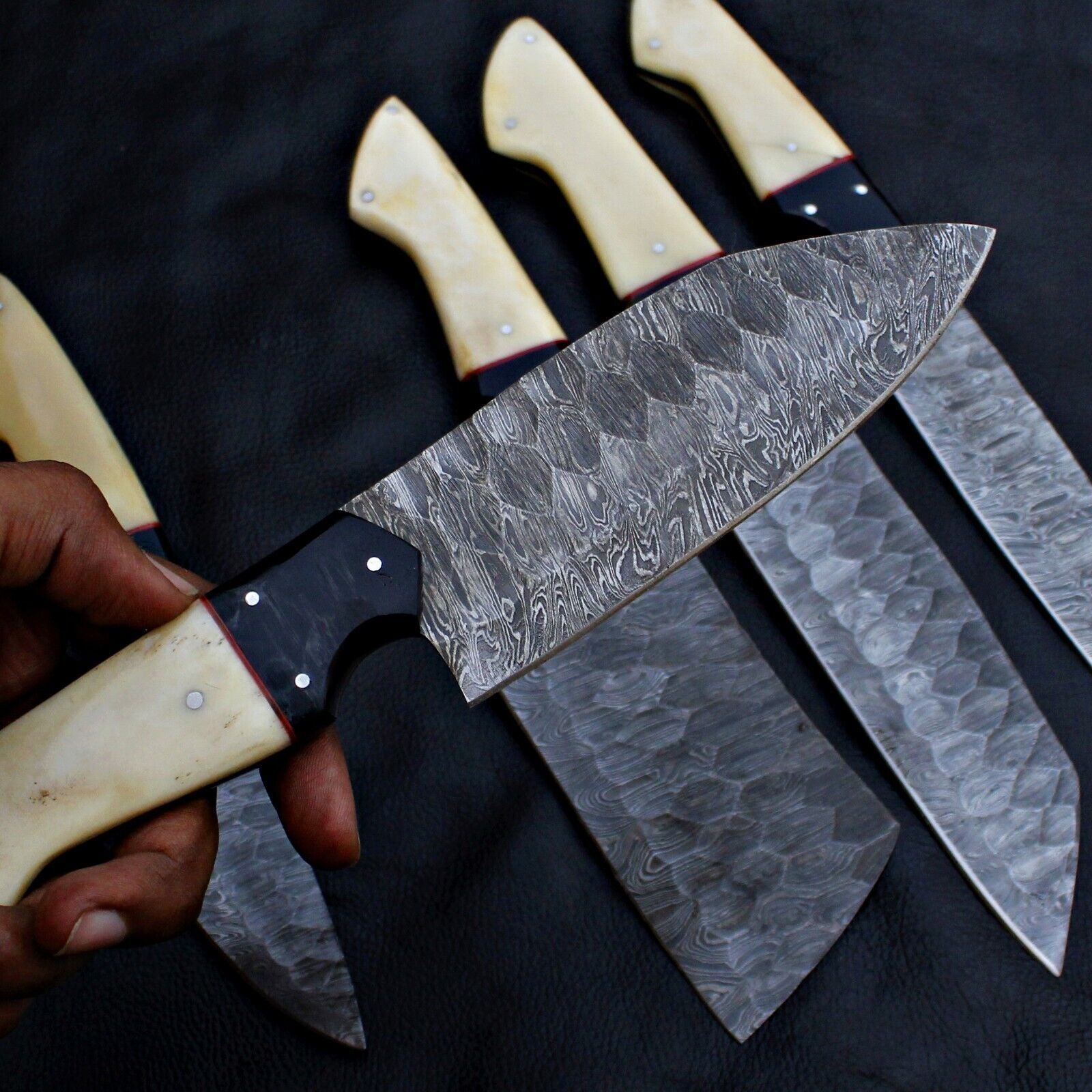Close up of unique, hand forged Damascus steel pattern on a professional kitchen chef knife.