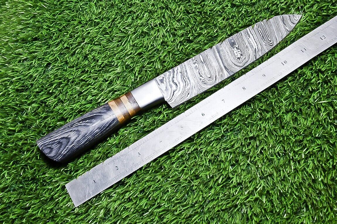 Side profile view of a custom Damascus kitchen knife highlighting the balanced steel bolster and ergonomic hardwood handle