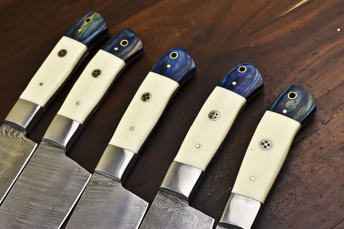 Detailed view of the unique camel bone handle scales and steel bolster on a handmade Damascus kitchen knife.