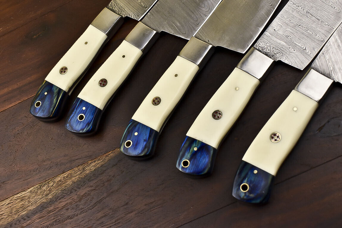 Detailed view of the unique camel bone handle scales and steel bolster on a handmade Damascus kitchen knife.