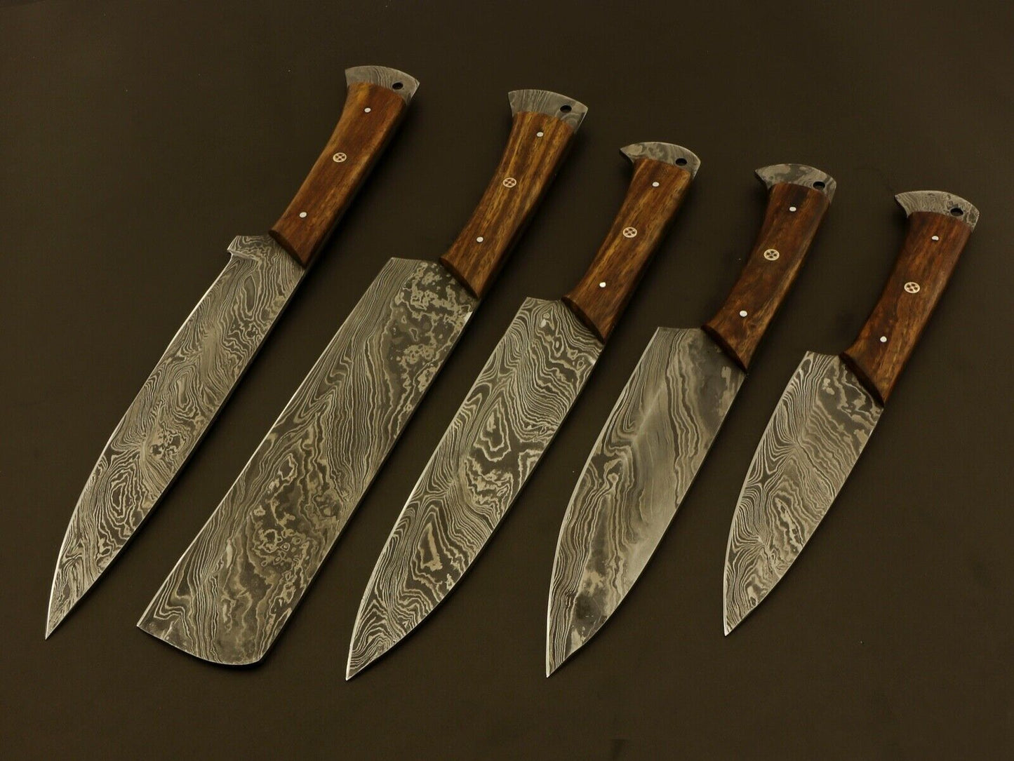 Collection of 5 handmade Damascus steel chef knives featuring wood handles and professional grade balance.