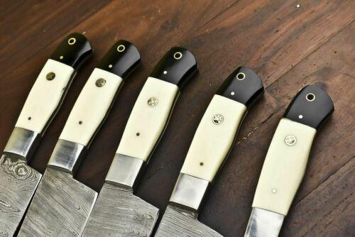 Close up of premium camel bone handle and polished silver bolster on a handcrafted Damascus steel kitchen knife.