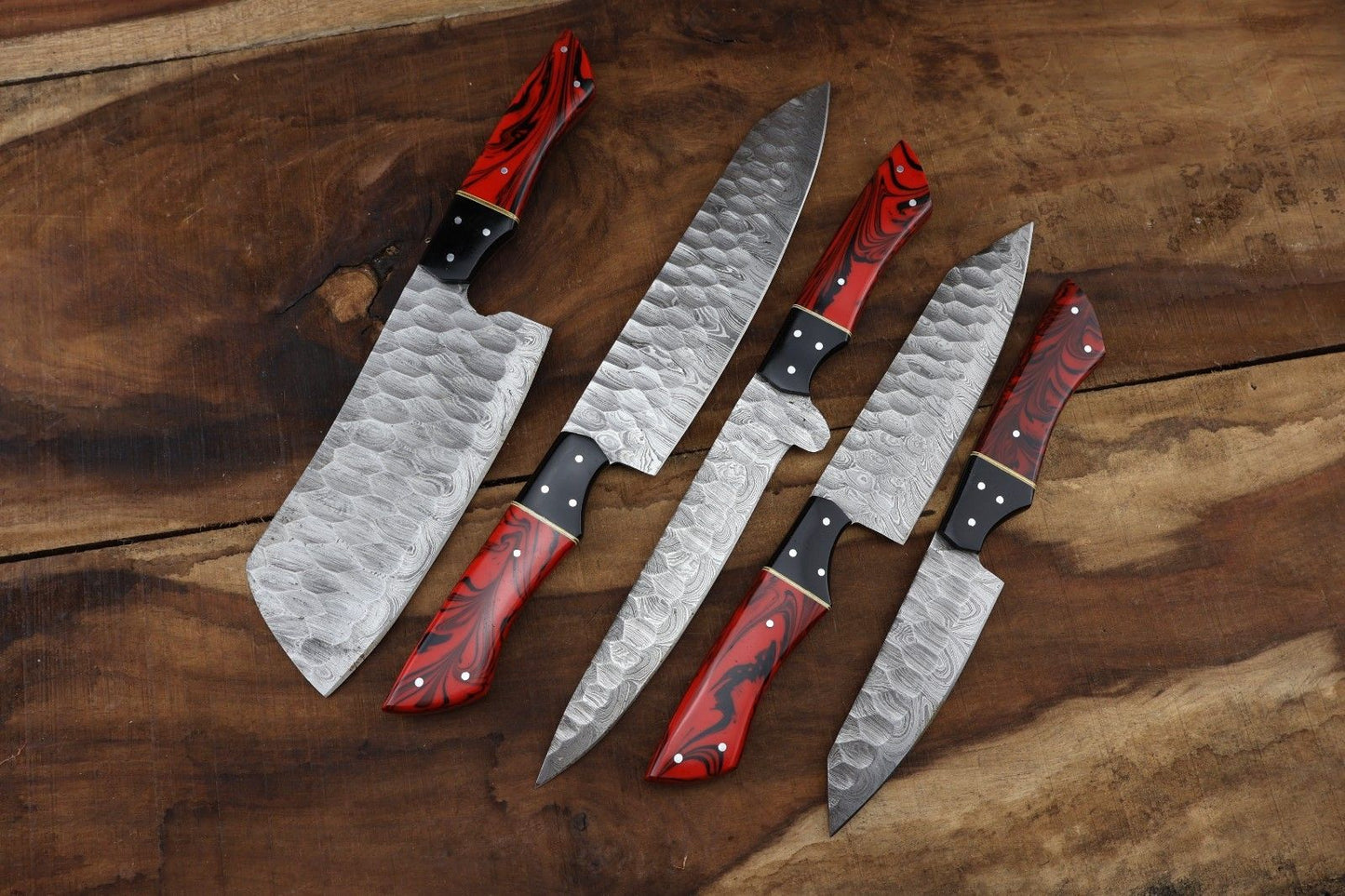 Detail view of the intricate 512 layer Damascus twist pattern and hand forged spine file work on a professional kitchen and hunting knife.