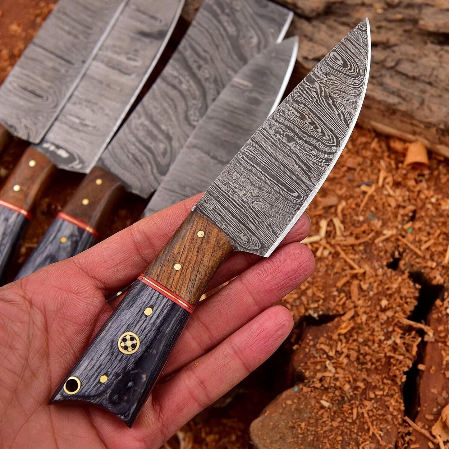 Close up of hand forged Damascus steel blade featuring unique twist pattern and razor sharp edge.