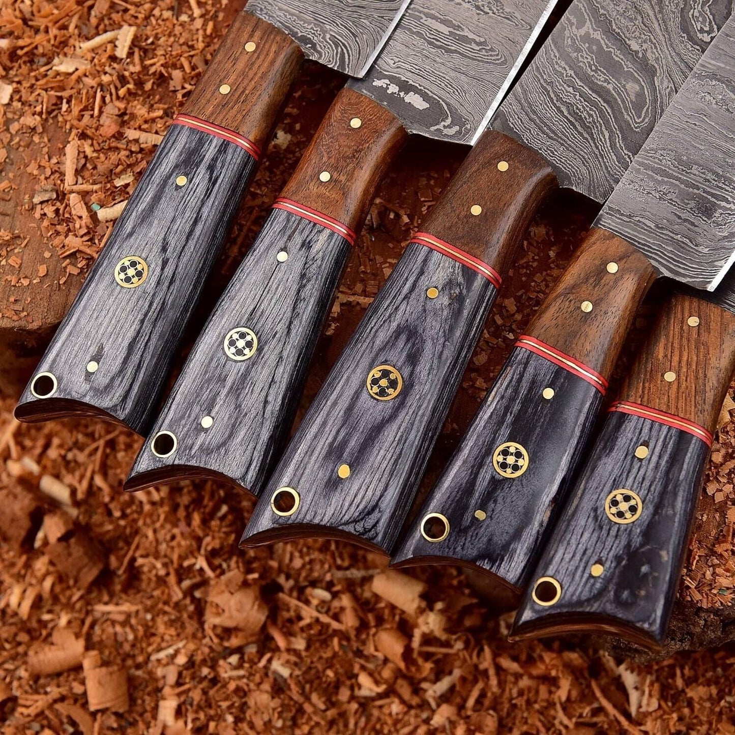 Detail of ergonomic rosewood and hardwood handle on a custom handmade Damascus chef knife.
