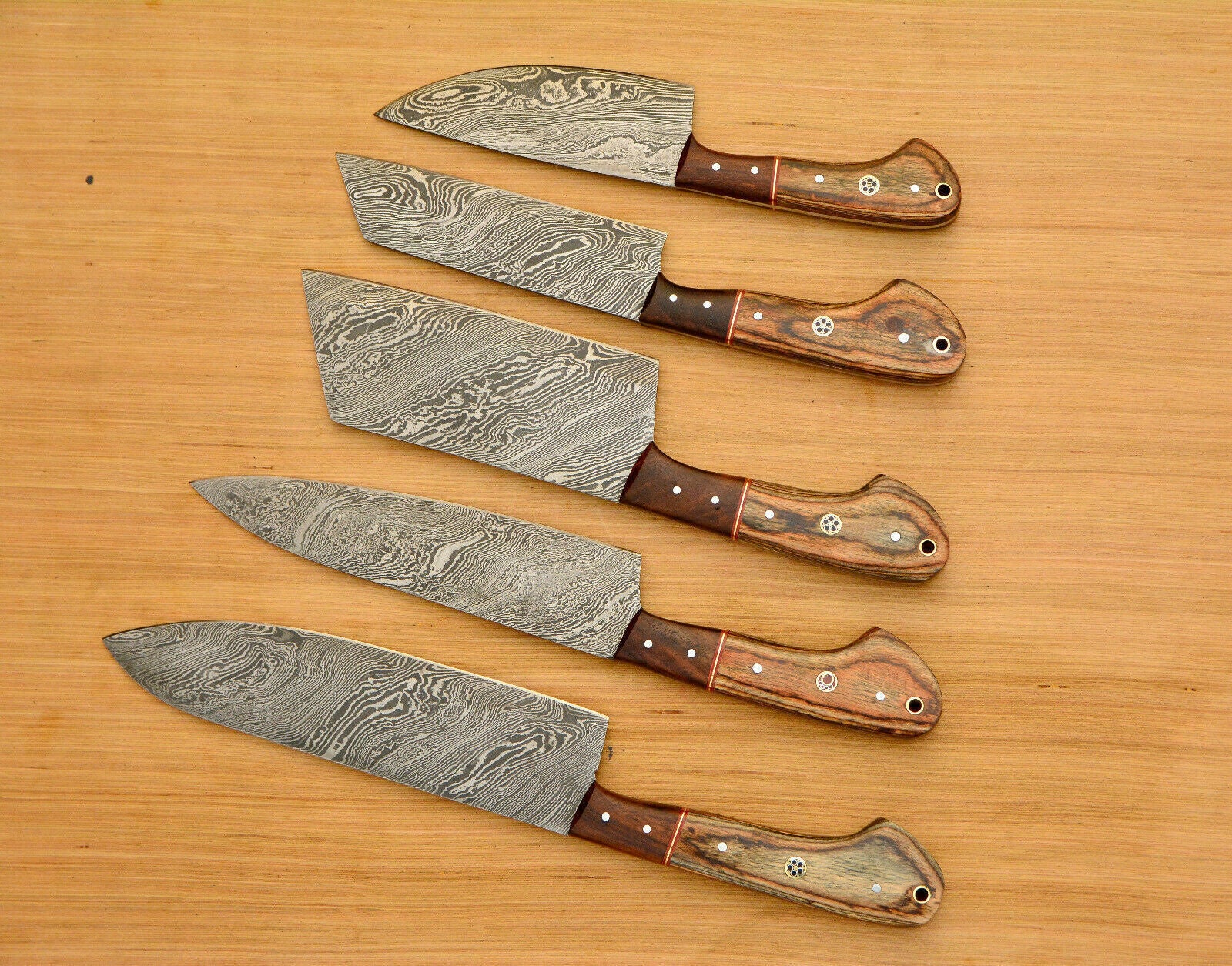 Close up of 512 layer hand forged Damascus steel blade featuring a mesmerizing twist pattern.