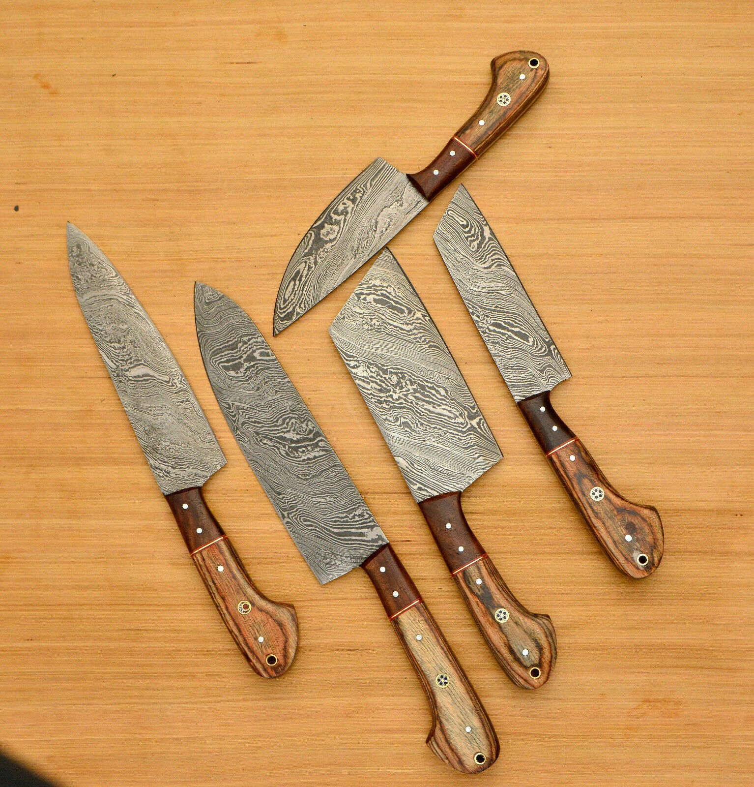 Detail view of premium natural wood handle on a custom handmade Damascus chef knife.