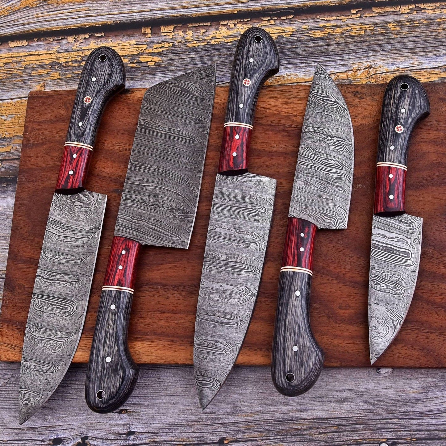 Close up of intricate mosaic pin detail and hand engraved bone texture on a custom Damascus steel chef knife handle.