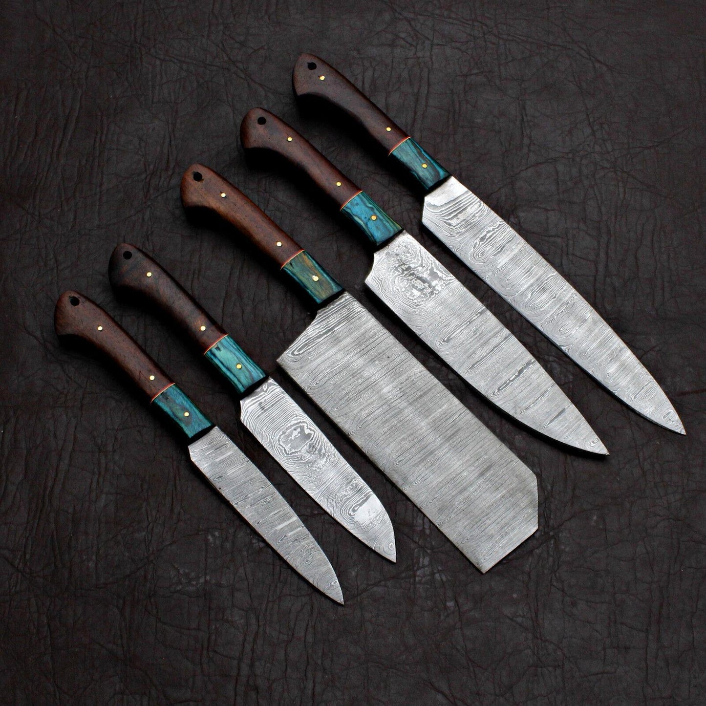 5-piece Black Beer custom handmade Damascus chef knife set on a rustic wooden background.