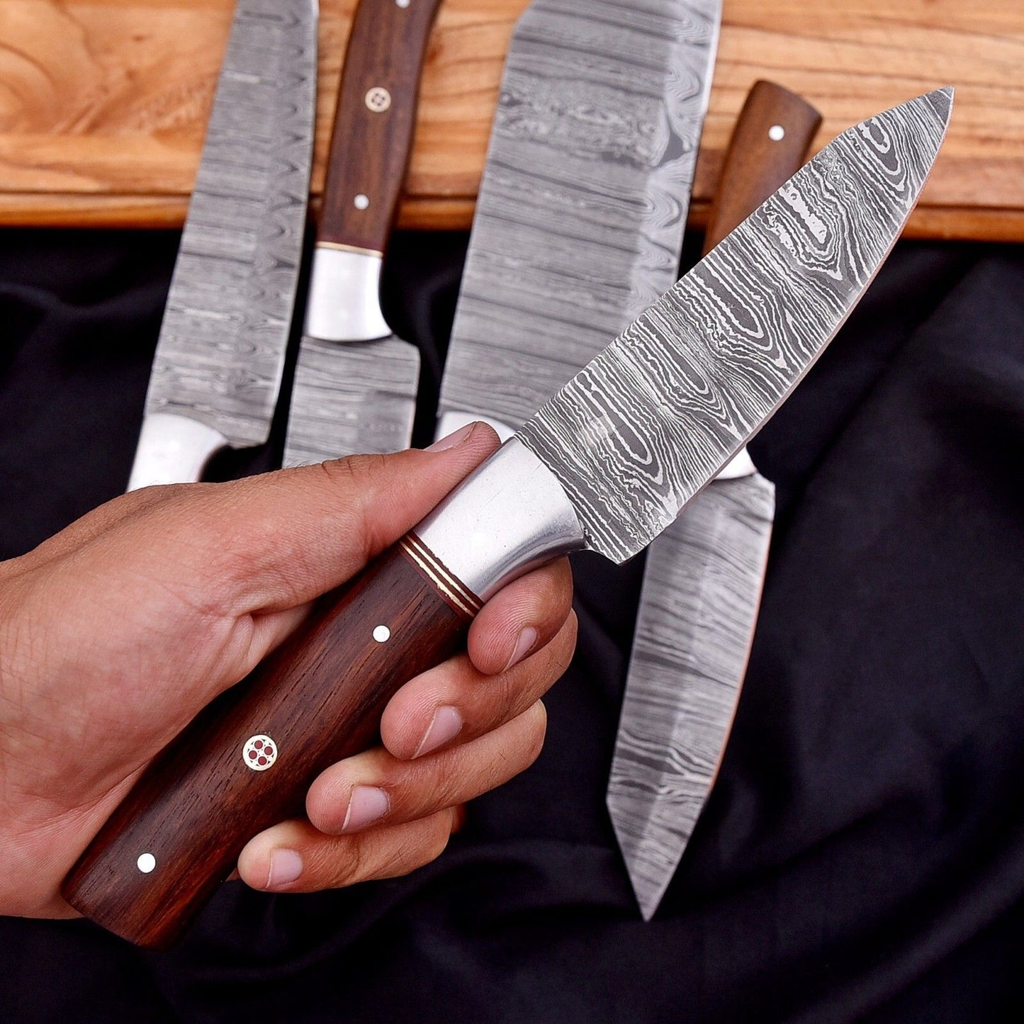 Detail view of the 512 layer hand forged twist pattern on a Damascus steel kitchen chef knife.