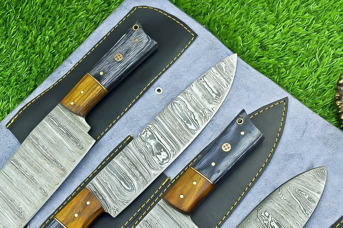 Handheld view of custom chef knife featuring ergonomic natural wood handle with decorative brass mosaic pin.