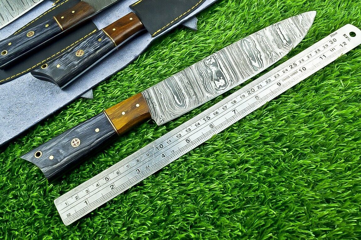 Close up of hand forged Damascus steel chef knife blade showing unique layered pattern and satin finish.