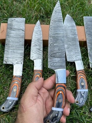 Detail view of handmade kitchen knife wooden handle with custom lanyard hole for storage