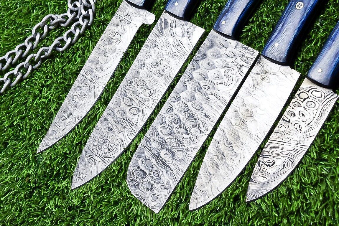 Close up detail of a Damascus steel kitchen knife blade showcasing the unique 384 layer pattern and satin finish.