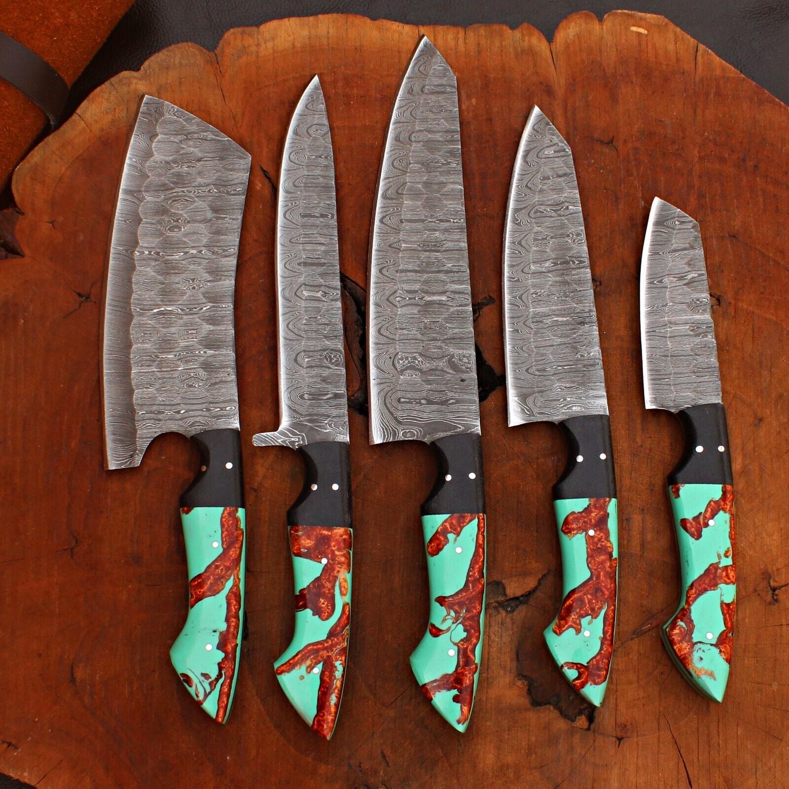 Macro detail of hand forged Damascus steel pattern on a professional chef knife blade with satin polished finish.