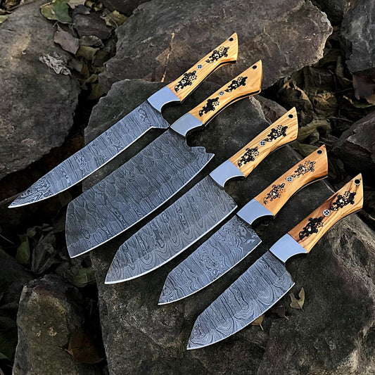5 pieces custom handmade Damascus chef knife set featuring forged steel blades and unique ergonomic handles on a rustic wood background.