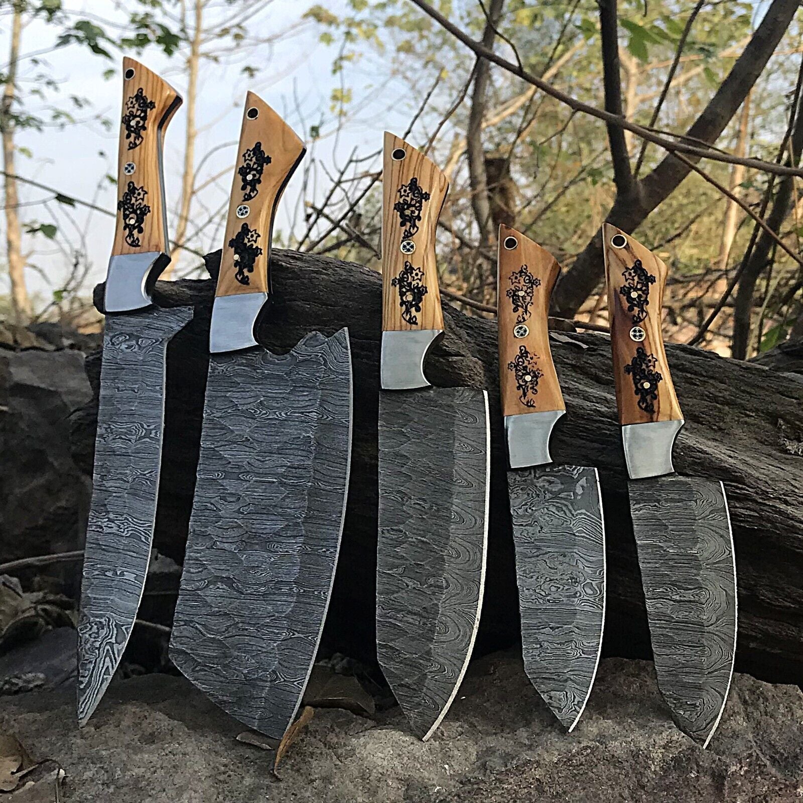 Close up of the hand forged Damascus steel pattern and satin polished finish on a professional kitchen knife blade.