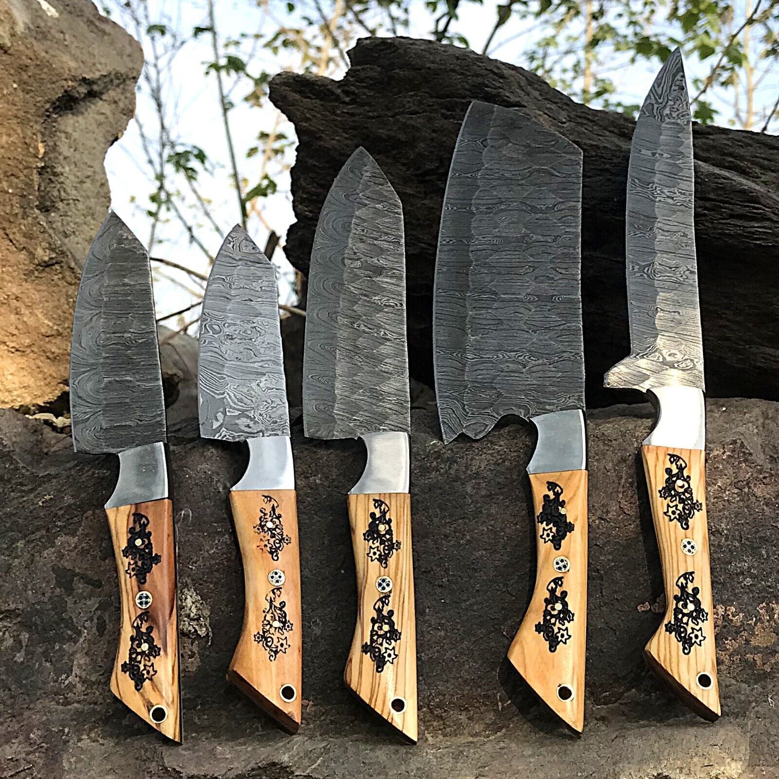 Detail shot of a custom handmade knife handle showing premium materials and expert craftsmanship for a Damascus chef knife set.