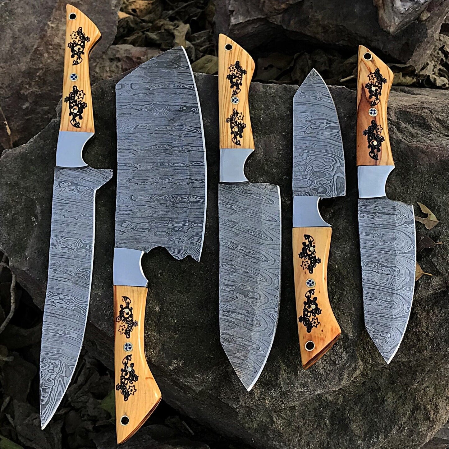 5 pieces custom handmade Damascus chef knife set featuring forged steel blades and unique ergonomic handles on a rustic wood background.