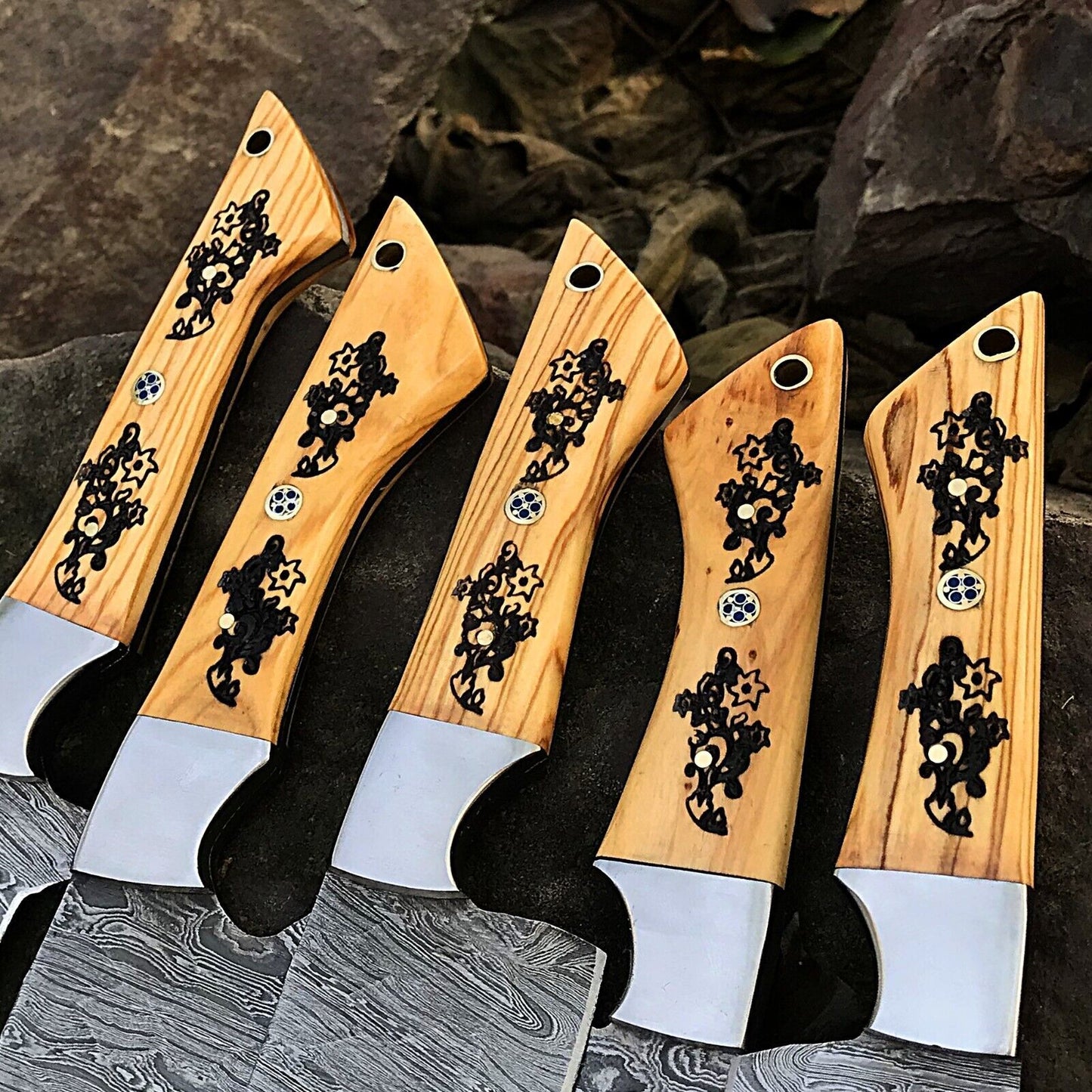 Detail shot of a custom handmade knife handle showing premium materials and expert craftsmanship for a Damascus chef knife set.