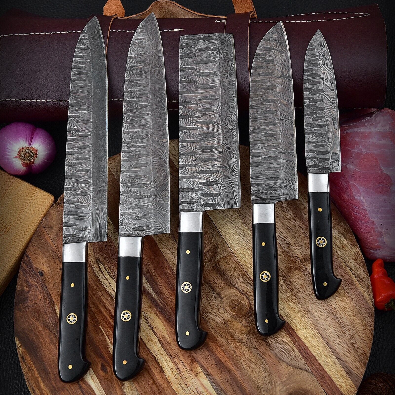 Professional Damascus steel kitchen knife collection displayed on a rustic wood surface, highlighting rugged bushcraft design and artisanal quality.