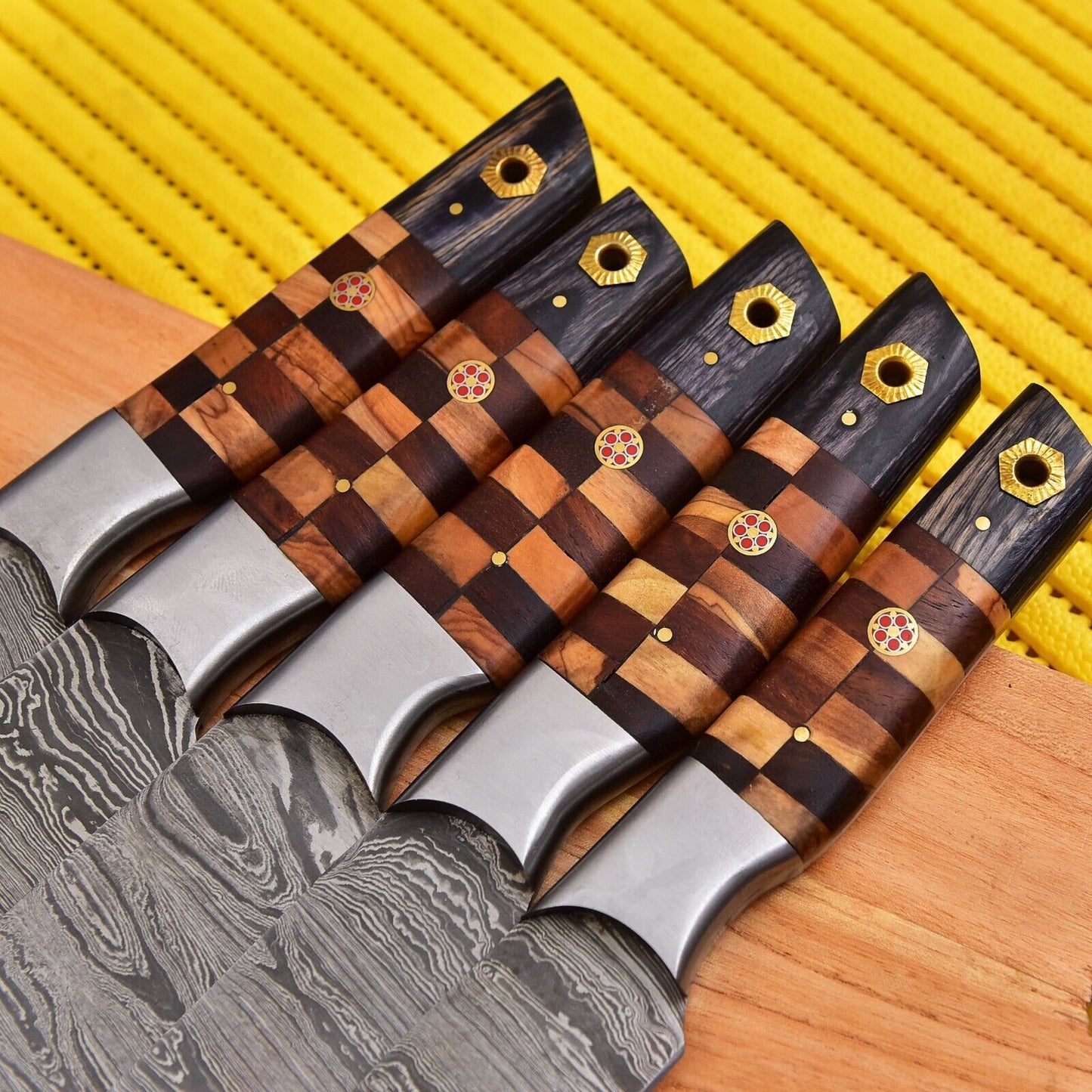 Close up view of 512 layer Damascus steel blade with a unique twist pattern and intricate spine file work.