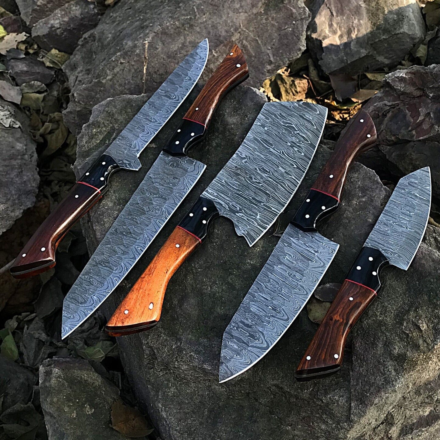 Close up of a hand forged Damascus steel kitchen knife blade showing the intricate pattern and professional satin polish.