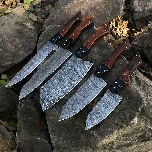 5 Pieces custom handmade Damascus chef knife set featuring forged steel blades and unique handle designs arranged on a wooden surface.