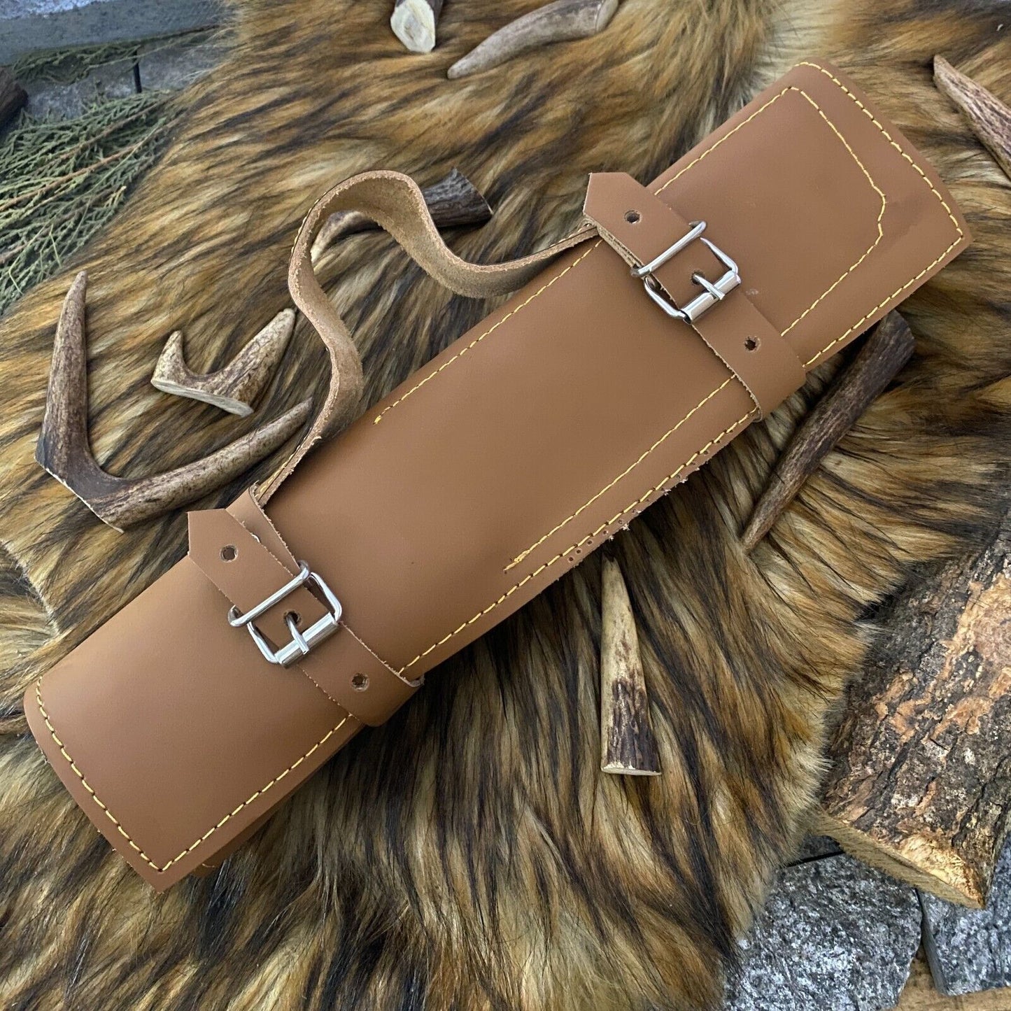 Professional kitchen knife set stored in a premium leather roll, ideal for travel or organized culinary storage.