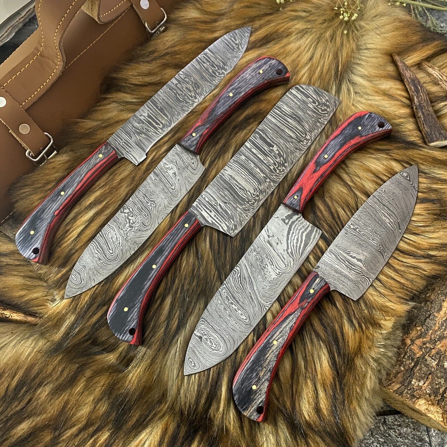 Professional kitchen knife set stored in a premium leather roll, ideal for travel or organized culinary storage.