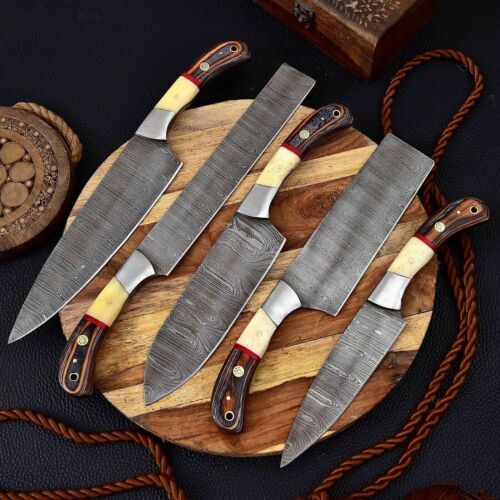 Gray Damascus steel clip point blade and protective sheath for handmade kitchen and outdoor knife set.