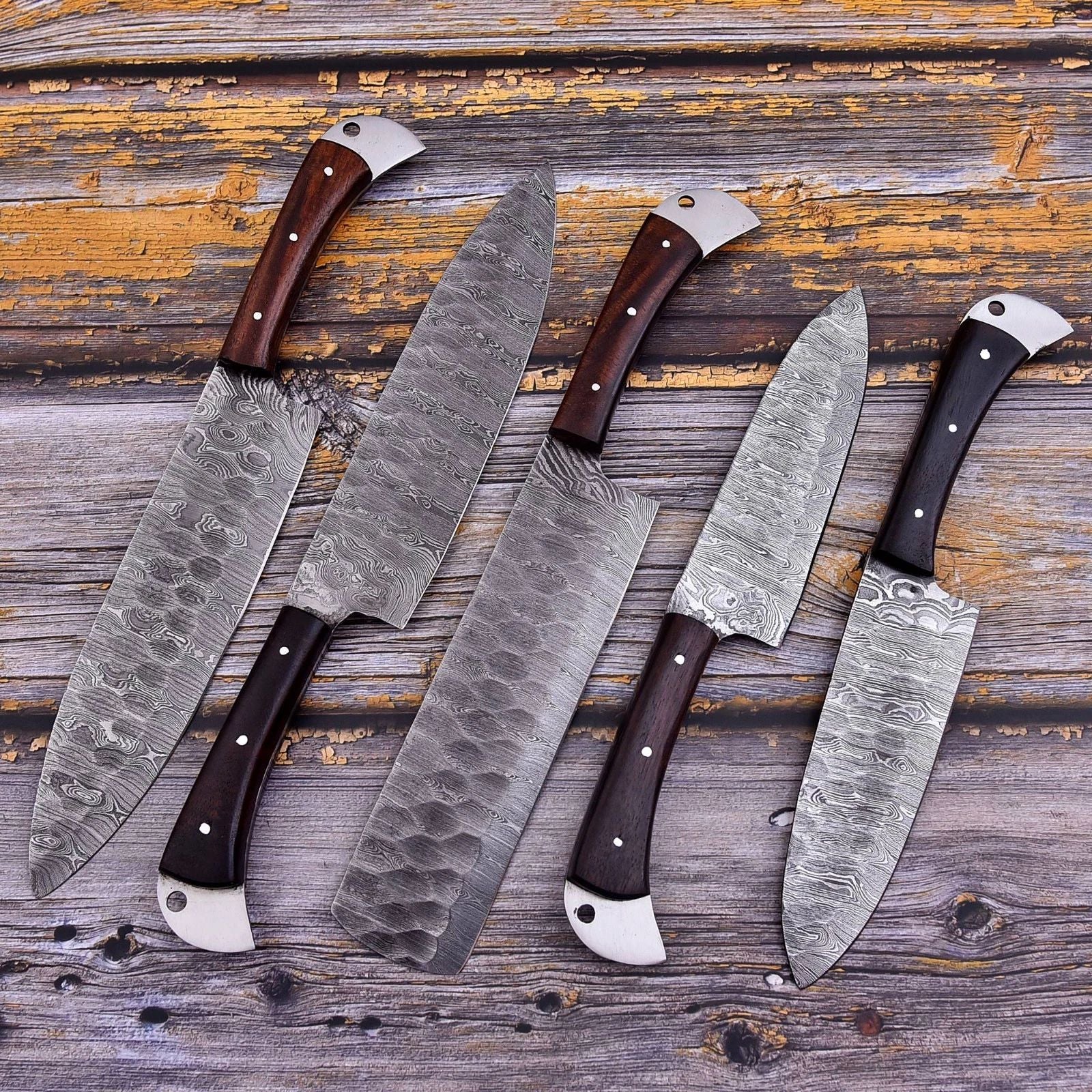 5 pieces custom Damascus steel kitchen knife set featuring hand forged blades and ergonomic wood handles with intricate mosaic pin detailing.