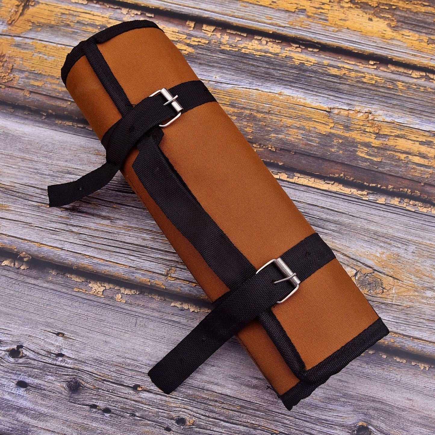 Handcrafted genuine leather knife roll featuring reinforced stitching and antique style hardware, designed to protect Damascus steel kitchen knives.