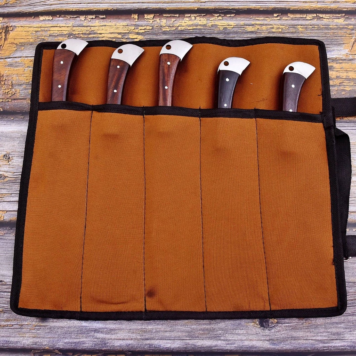Handcrafted genuine leather knife roll featuring reinforced stitching and antique style hardware, designed to protect Damascus steel kitchen knives.