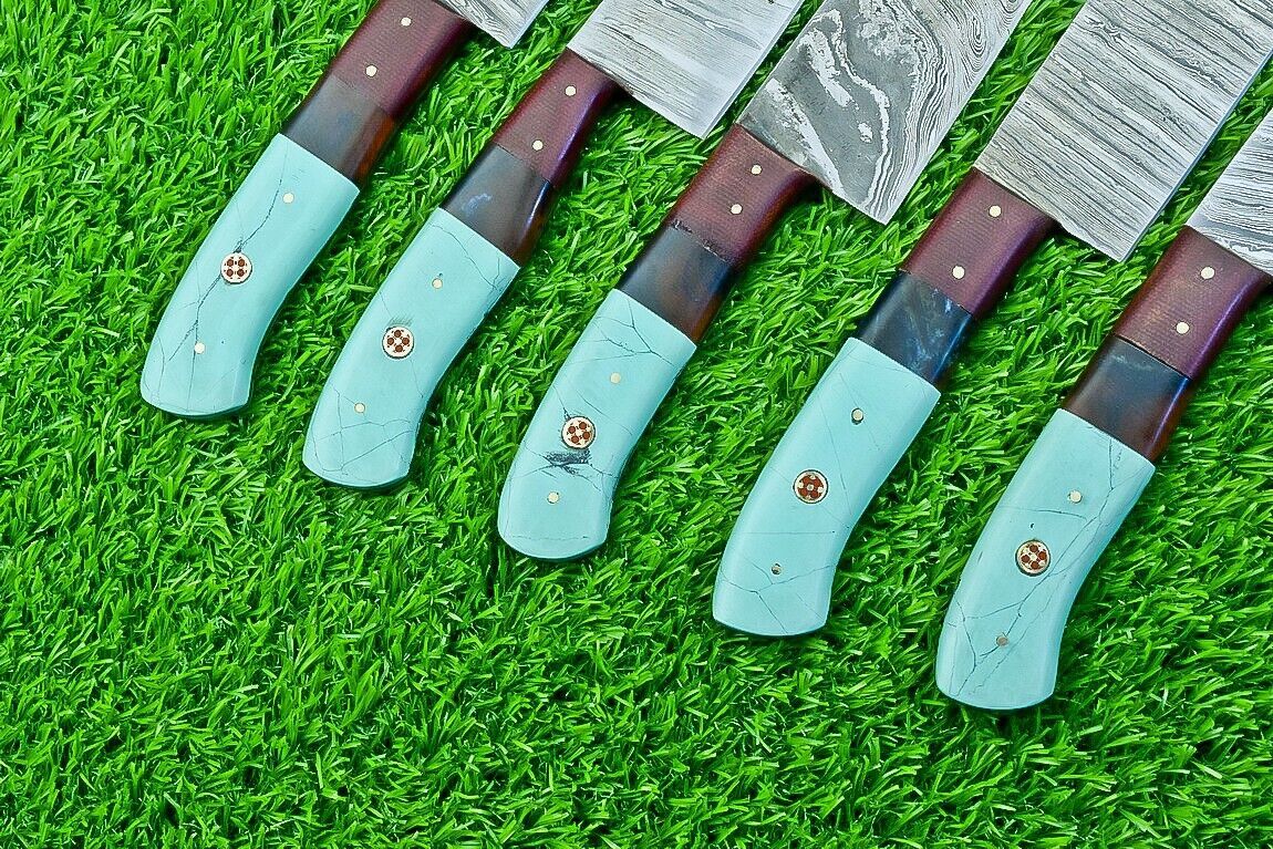 Detailed shot of a custom chef knife handle crafted from premium resin and micarta, featuring decorative brass and mosaic pins.