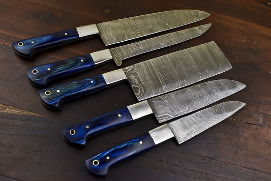 Premium 5 pieces Damascus kitchen knife set featuring hardwood handles and steel bolsters displayed on rustic timber.