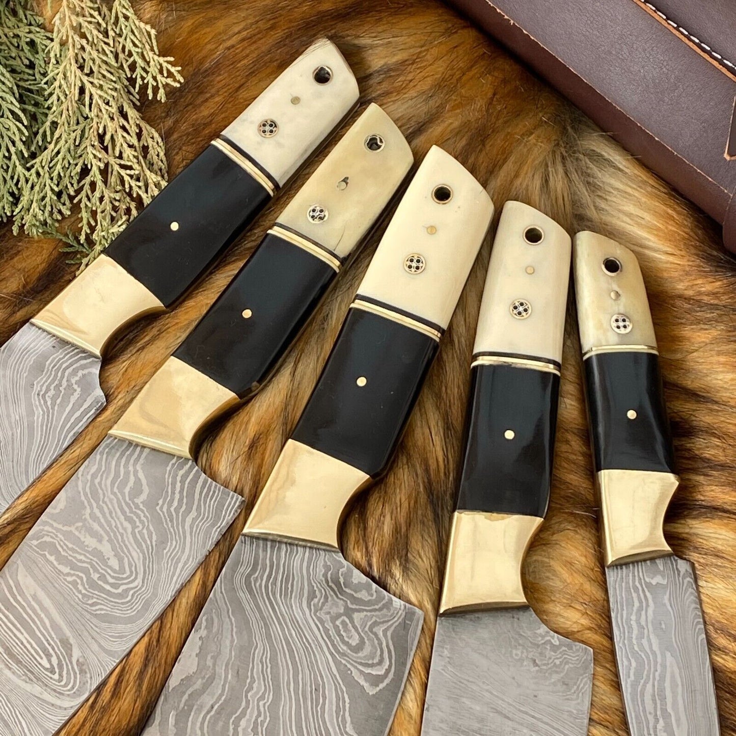 Close up of a professional black coated chef knife featuring a unique bone and horn handle design.