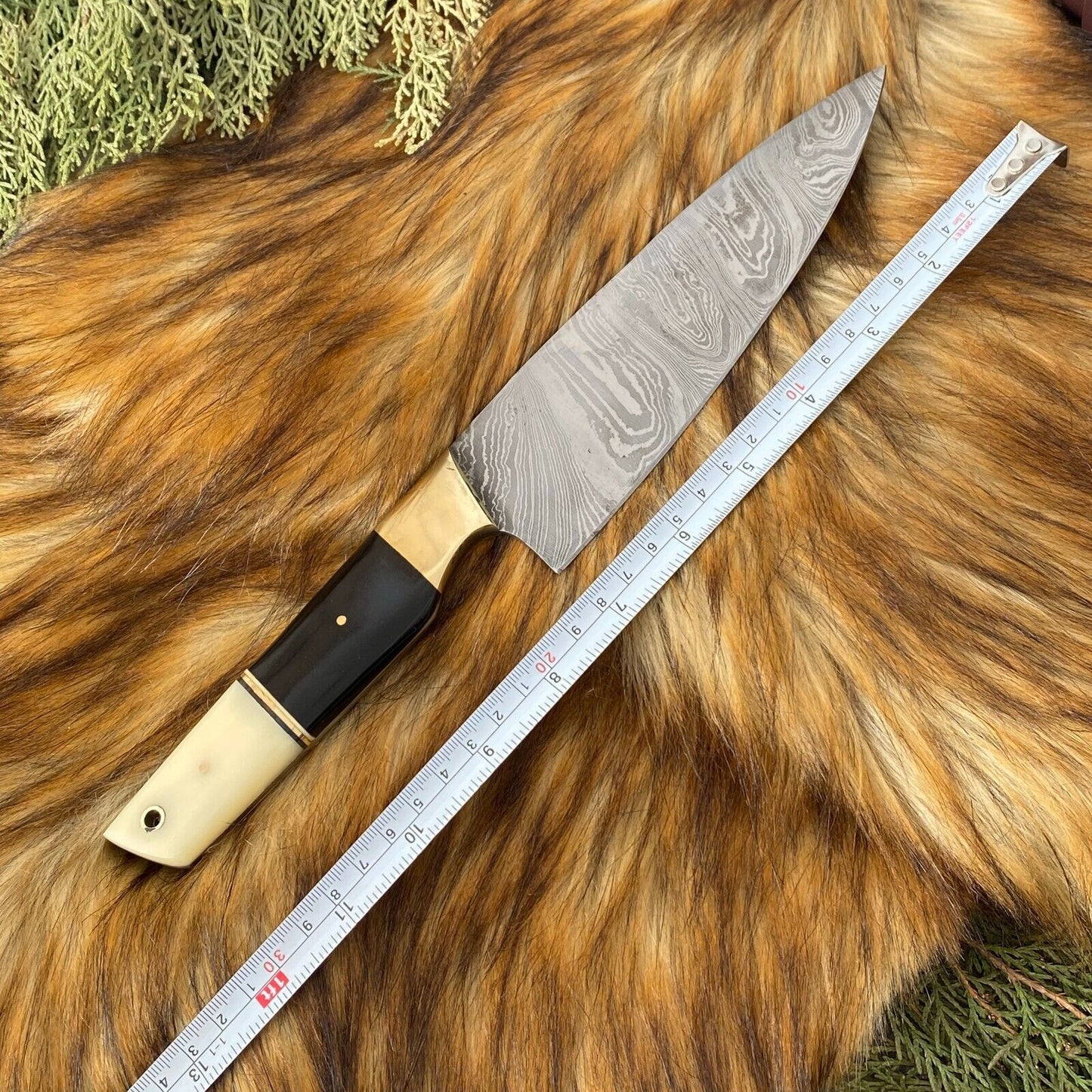 Handmade bone and horn handle detail on a custom chef knife set, showcasing unique artisanal texture.