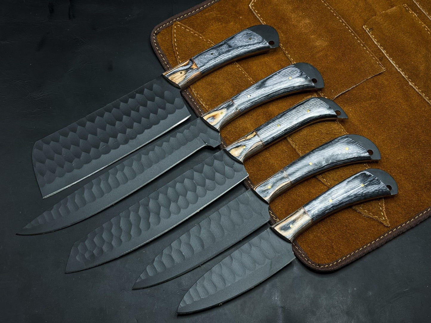 Handmade 5 piece carbon steel kitchen and survival knife set with wood handles and leather sheaths.