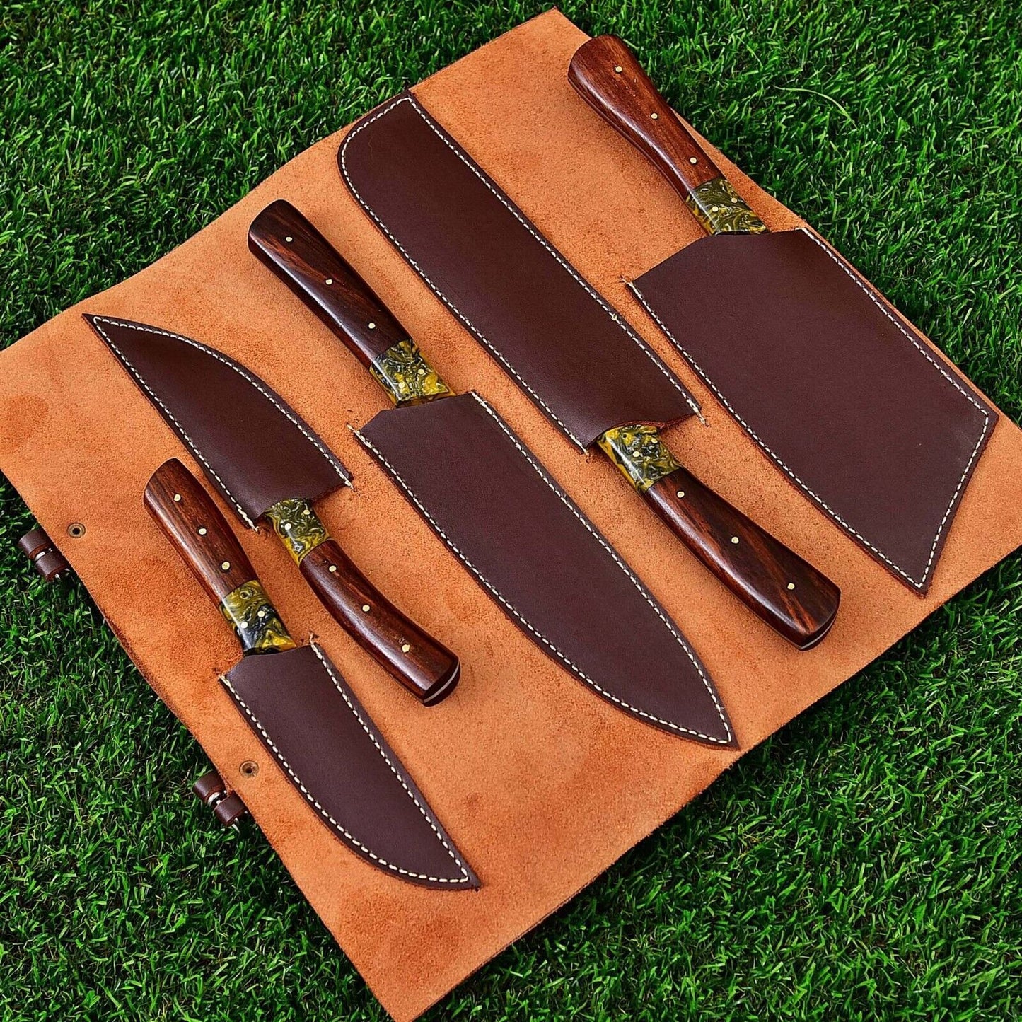 Professional Damascus steel kitchen knife set and leather sheath displayed on a rustic surface, showcasing craftsmanship and blade quality.